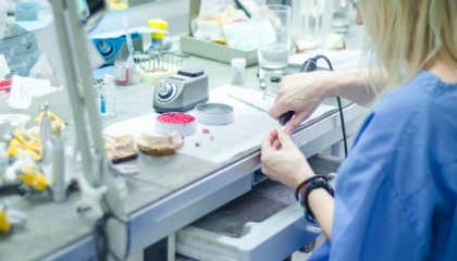 Dental technician at the workbench in the laboratory
