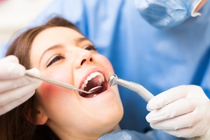 Young woman in the treatment chair with her mouth open